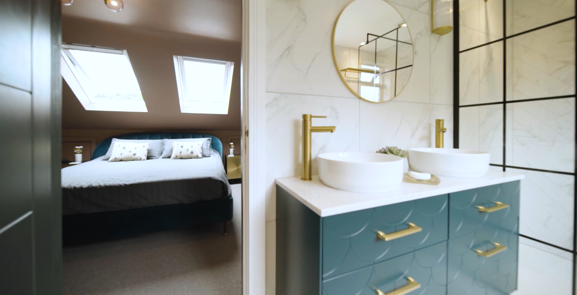 Modern bathroom interior with round mirror, wall-mounted tap and blue vanity cabinet.